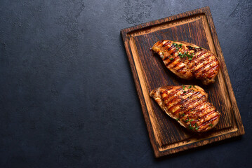 Grilled spicy chicken breasts. Top view with copy space. - 781939404