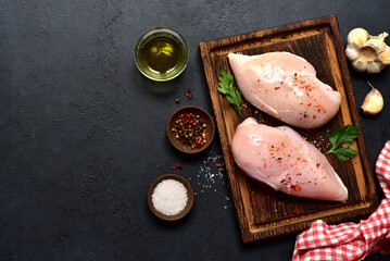 Raw chicken fillet or breasts with ingredients for cooking. Top view with copy space. - 781941033
