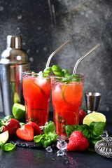 Cold summer strawberry cocktail with lime and basil in a  glasses . - 781941407