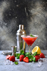 Cold summer strawberry cocktail with lemon and basil in a  martini  glasses . - 781942286