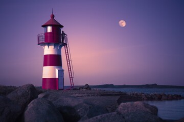 A towering beacon guiding ships through treacherous waters, a lighthouse stands sentinel against...