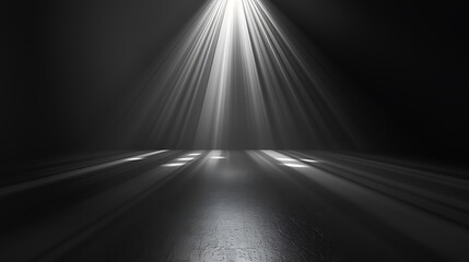 A spotlight shines down on a dark stage. The spotlight is surrounded by a soft, hazy light. The stage is empty, except for a few shadows.
