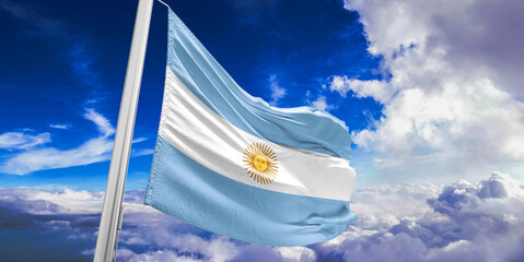 Argentina national flag cloth fabric waving on beautiful Blue Sky Background.