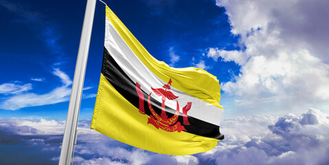 Brunei national flag cloth fabric waving on beautiful Blue Sky Background.