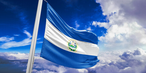 El Salvador national flag cloth fabric waving on beautiful Blue Sky Background.