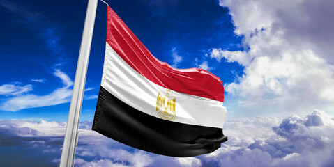 Egypt national flag cloth fabric waving on beautiful Blue Sky Background.