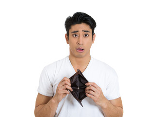 Sad desperate man with an empty wallet isolated on white background  - 781951438