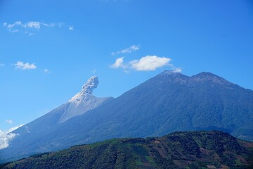 Fototapeta premium Aerial view of mountain landscape surrounded by dense trees