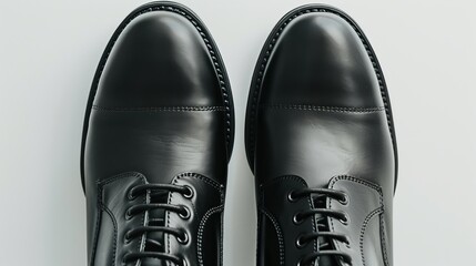 close-up Men's black shoes against a white backdrop. - obrazy, fototapety, plakaty