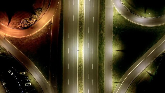 Aerial time-lapse of traffic on a junction at night
