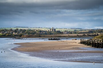 Distant view of the Warkworth Castle from Amble Harbor, Northumberland, England