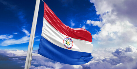 Paraguay national flag cloth fabric waving on beautiful Blue Sky Background.