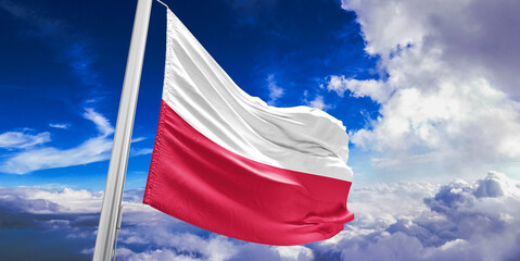 Poland national flag cloth fabric waving on beautiful Blue Sky Background.