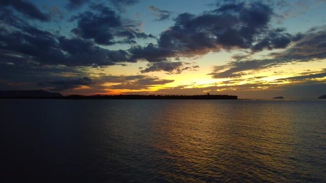Aerial time lapse video of a beautiful sunset at Pasir Pandak beach, Santubong Sarawak, Malaysia