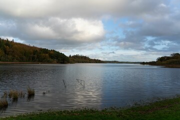 Peaceful lake Muckno in County Monaghan, Ireland with fluffy clouds in the background