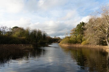 Peaceful lake Muckno in County Monaghan, Ireland with fluffy clouds in the background