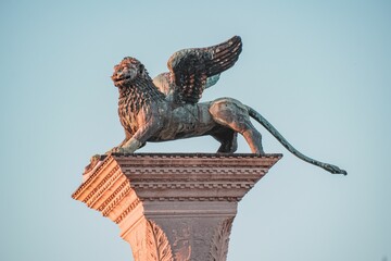 Lion of Venice sculpture on a blue sky background in Venice, Italy