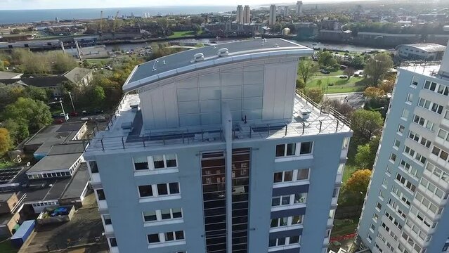 Aerial drone footage of an apartment building and the cityscape