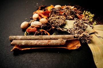 Closeup shot of indian garam masala and spices on the black background