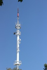 Vertical shot of the Radio broadcasting mast against the blue sky