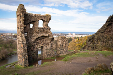 Arthur's Seat volcano with ruins of saint anthony's chapel in Edinburgh, Scotland with view on seaside