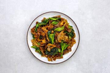 Stir-fried rice noodles with soy sauce and pork