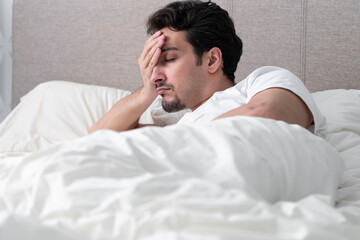 Young handsome man sleeping in the bed at the morning time	
