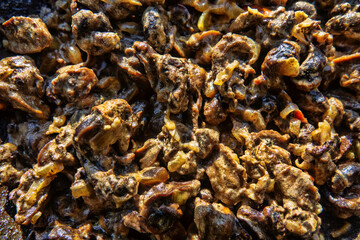 Hiker's food. Grape snails fried in a frying pan with vegetables
