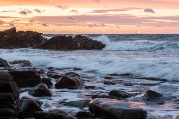 Scenic shot of foamy waves crashing the stone on the shore in Hovs-hallar, Sweden