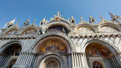 Low angle shot of Saint Mark's Basilica in Venice with sculptures in gothic style