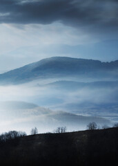 mysterious landscape with hills in fog - 781979445