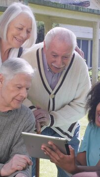 Happy elderly people spending time together outdoor. Vertical Video