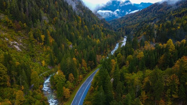 Beautiful view of a European highway in Autumn by a brook