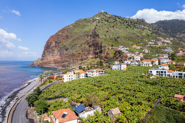 Aerial view of small farming village with banana plantation at Madeira Atlantic Ocean coast