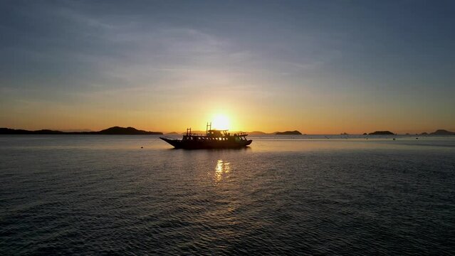Traditional philippine boat bangka at sunset time in Linapacan, Philippines. Orange sky sunset paradise beach.