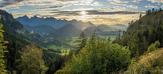 Aerial view of mountain landscape surrounded by dense trees - obrazy, fototapety, plakaty