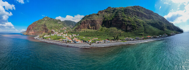 Aerial view of small farming village with banana plantation at Madeira Atlantic Ocean coast - 781983283