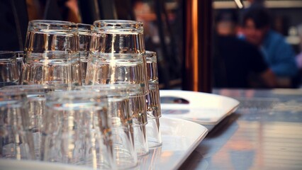 Selective focus shot of clean glasses on a tray in a bar