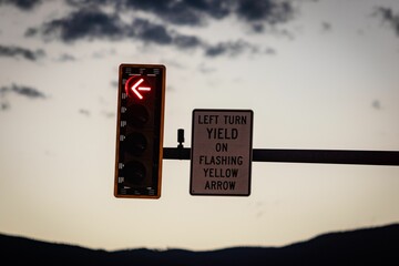 Closeup shot of a traffic light and sign indicating 