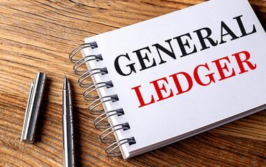 GENERAL LEDGER text on notebook with pen on the wooden background