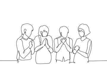 men and women stand with their palms folded in a praying gesture - one line art vector. hand drawn illustration of different gender people praying, saying affirmations or mantra