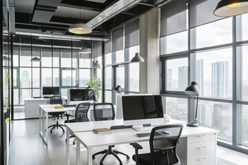 Workspace that marries the tranquility of an organized desk with the energetic backdrop of a cityscape - obrazy, fototapety, plakaty