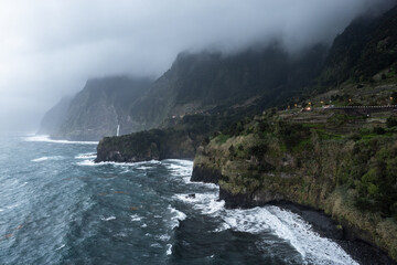 Aerial drone view  of the coast of Seixal at cloudy dramatic weather, Madeira, Portugal, Europe - 781990015