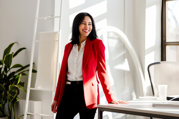  a woman dressed in a stylish red blazer exudes confidence