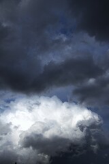 dramatic sky with contrasting cloud formations, ominous storm clouds. concepts: book cover for...