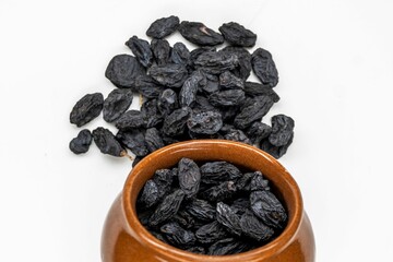 Heap Of Black Raisins, Black Raisins in Bowl Isolated On White Background