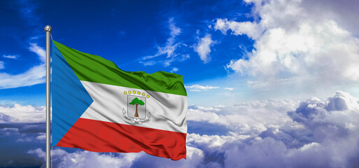 Equatorial Guinea national flag cloth fabric waving on beautiful Blue Sky Background.