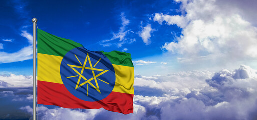 Ethiopia national flag cloth fabric waving on beautiful Blue Sky Background.
