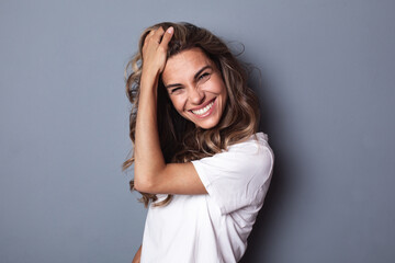 Portrait of young woman casual portrait in positive look, wide smile beautiful model posing in...