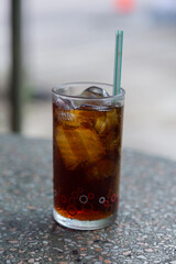 Cola with crushed ice and a straw in a clear glass is ready to drink to quench your thirsty